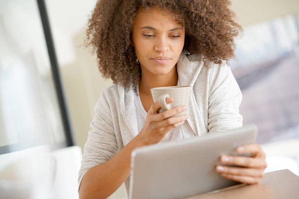 woman at home using tablet  - Фото, изображение