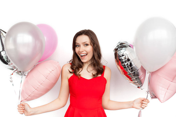 Woman in dress posing with balloons - 写真・画像