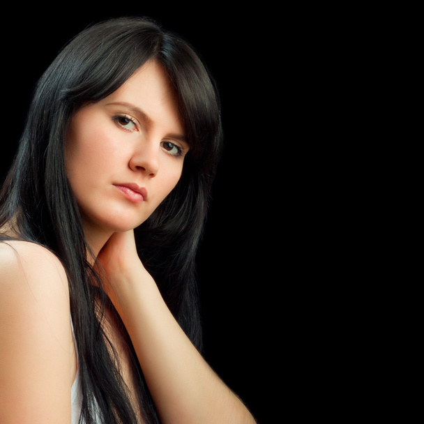 Portrait of a beautiful young woman holding her neck isolated on - Photo, image