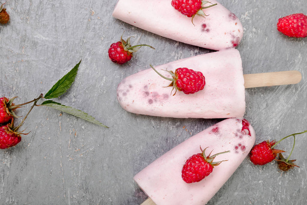 Raspberry ice cream on grey background. Three popsicles. Top view. Homemade. - Fotoğraf, Görsel