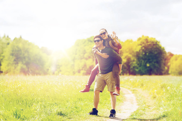 happy couple with backpacks having fun outdoors - 写真・画像