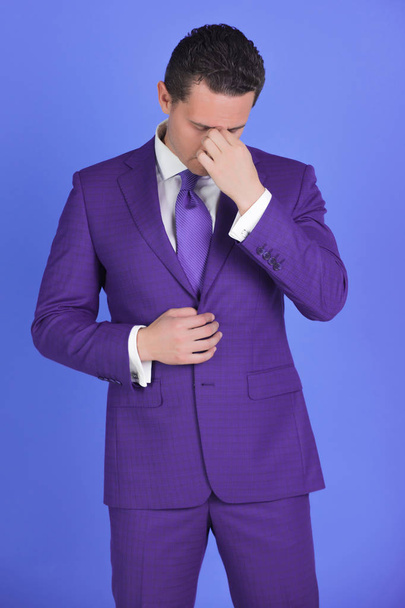 Tired man feeling headache with stylish hair in fashionable suit - 写真・画像