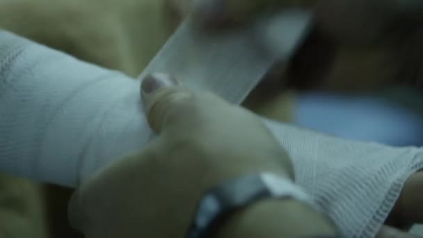 Trainer wrapping hand of male boxer. Boxers hand is being bandaged by coach - Materiaali, video