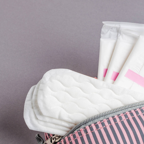 Menstrual tampons and pads in cosmetic bag. Menstruation time. Hygiene and protection - Photo, Image