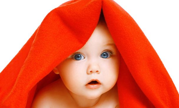 Portrait close-up of face cute baby under red towel on a white b - Foto, immagini