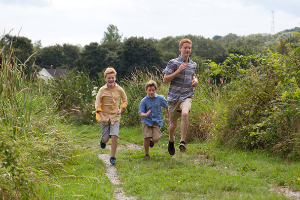 boys running in a field  - Photo, image