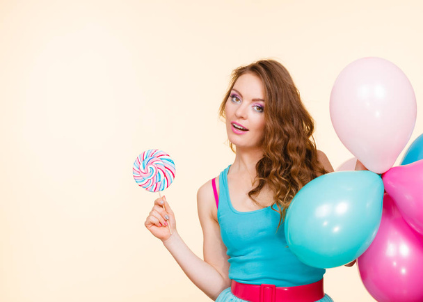 Woman with colorful balloons and lollipop - 写真・画像