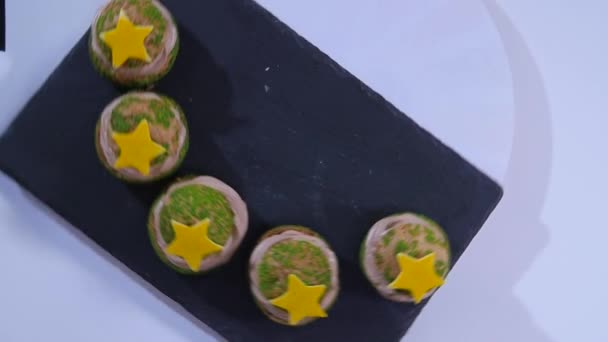 Top view of decorated cookie. Biscuit with bright icing. You can touch the star. Crispy dessert on white table. Fruit and chocolate homemade cake Slow motion - Séquence, vidéo