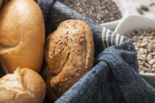 fresh rolls and freshly baked bread with variety of healthy seeds - Photo, Image