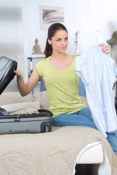 young woman packing a bag - Photo, Image