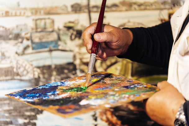 Close up of man artist painting oils in his studio. - Fotografie, Obrázek
