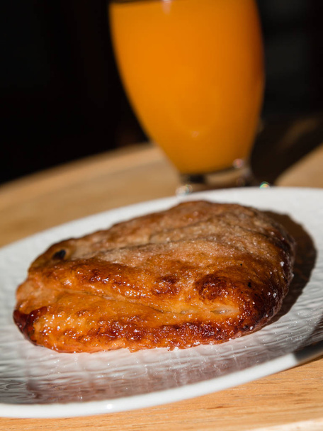 Fried Pastry Filled with Cream and Glass of Apricot Juice for Br - Photo, Image