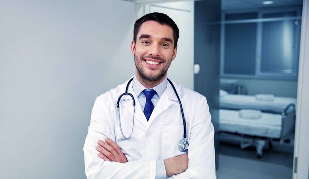 smiling doctor with stethoscope at hospital - Photo, Image