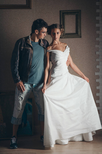 The guy and the girl emotionally communicate in the image of the bride and groom, in the fairy-tale interior. Fashion image of models - Photo, Image