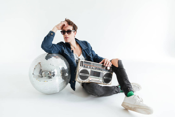Handsome young man with disco ball and boombox - Фото, зображення