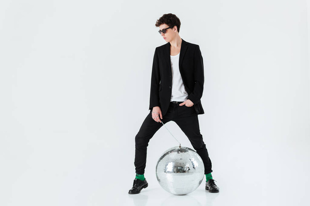 Full length portrait of man in suit with disco ball - Фото, изображение