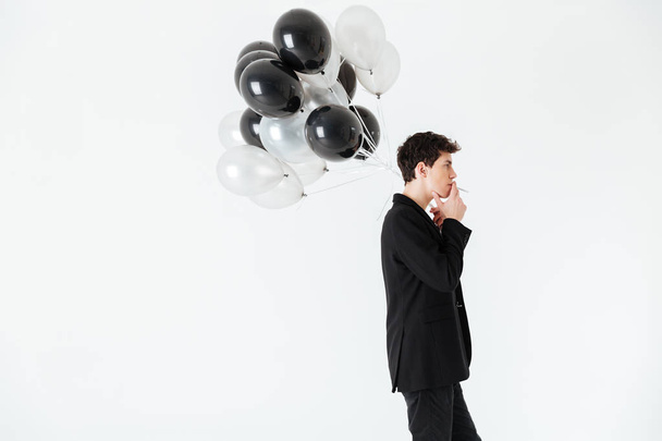 Calm Man holding air balloons and smoking cigarette - Zdjęcie, obraz