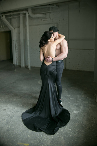 bearded man hugging a girl in a black dress - Foto, imagen