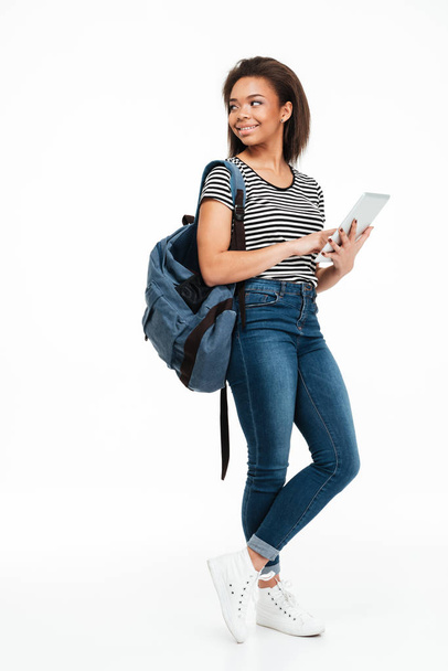 Full length portrait of a smiling teenage girl wearing backpack - Zdjęcie, obraz