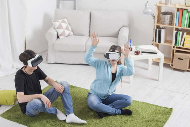 Virtual reality. Teens with virtual glasses are playing in the l - Zdjęcie, obraz