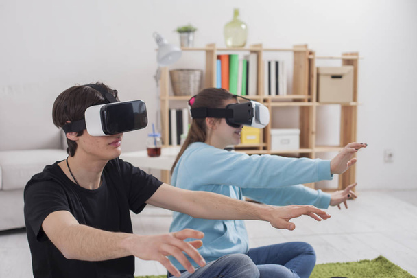 Virtual reality. Teens with virtual glasses are playing in the l - Fotoğraf, Görsel
