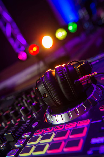 Dj mixer with headphones at a nightclub - Photo, image
