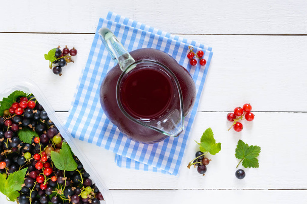 Cooling summer drink with berries - compote in a jug - Fotó, kép