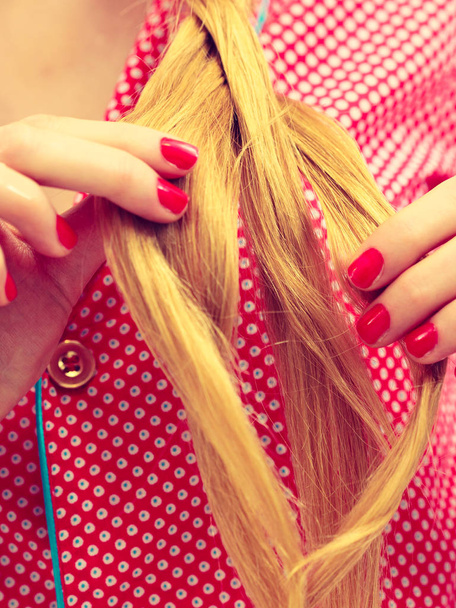 Closeup of woman doing braid on blonde hair - Zdjęcie, obraz