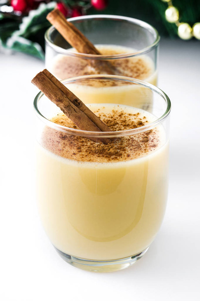 Homemade eggnog with cinnamon isolated on white background. Typical Christmas dessert. - Fotografie, Obrázek