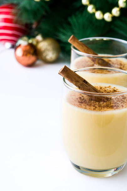 Homemade eggnog with cinnamon isolated on white background. Typical Christmas dessert. - Φωτογραφία, εικόνα