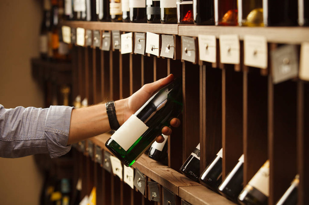 Expert in winemaking choose elite white wine in cellar. - Valokuva, kuva