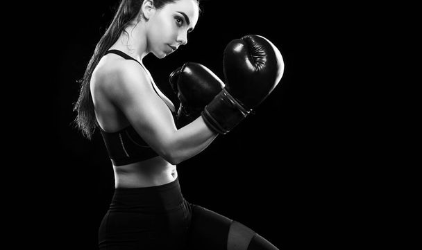 Woman boxer fighting in boxing cage. Isolated on black background. Copy Space. Black and white photo. - Fotó, kép
