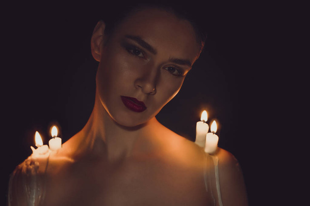 Красива жінка зі свічками на плечах
 - Фото, зображення