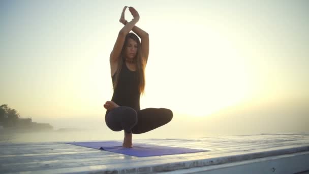 woman slim black wear do lotus meditate yoga pose sunrise fog rapid slow motion - Footage, Video