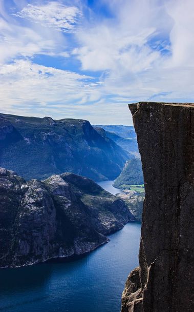 Beautiful summer view of Preikestolen (Preacher's Pulpit Rock), Stavanger, Norway. Lysefjord background. Blank space for model on perch for concept or abstract, triumph, goal, perseverance - Valokuva, kuva