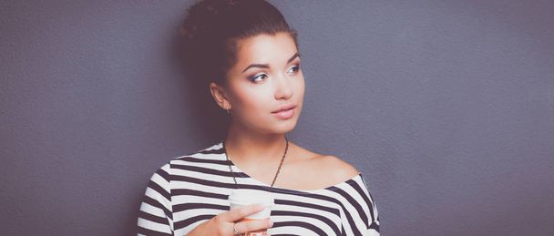 Portrait of young woman with cup tea or coffee - Photo, image