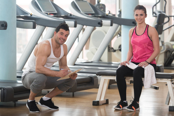 Trainer Takes Notes While Woman Sitting and Resting - Foto, Imagen