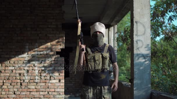 Mann posiert mit Waffe in Gebäude - Filmmaterial, Video