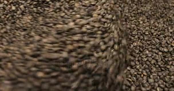 Roasting Coffee Beans Whirling Mixed On Cooling Unit Platform In A Manufactory Workshop, close-up - Materiał filmowy, wideo