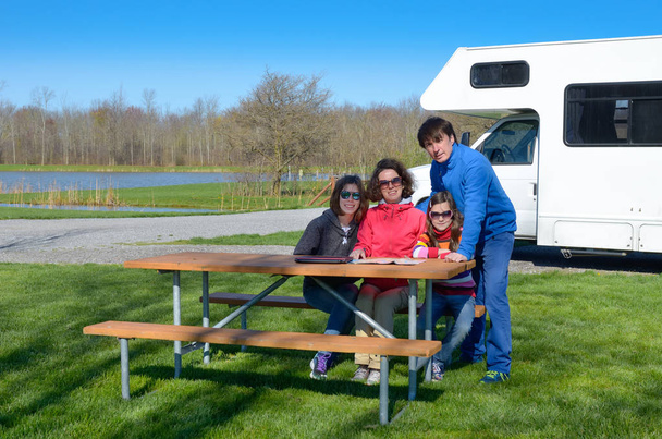 Family vacation, RV travel with kids, happy parents with children have fun on holiday trip in motorhome, camper exterior - Fotó, kép