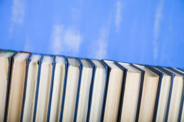 Stack of books on a blue background.  - Fotoğraf, Görsel