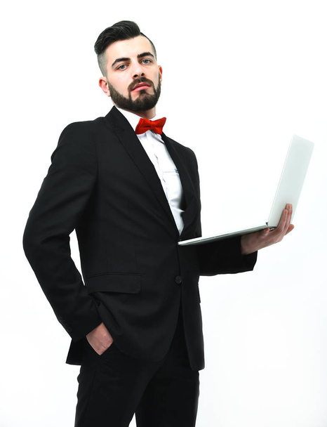 Confident businessman or head manager with beard holds white laptop - Фото, зображення