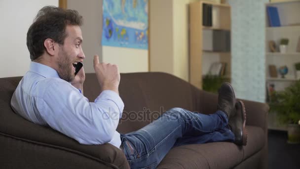 Joyful man talking on cellphone and smiling, nice conversation and relaxation - Filmmaterial, Video