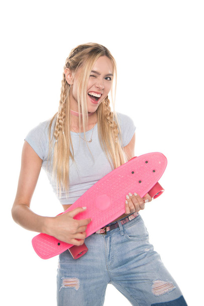Young woman with skateboard  - Фото, изображение