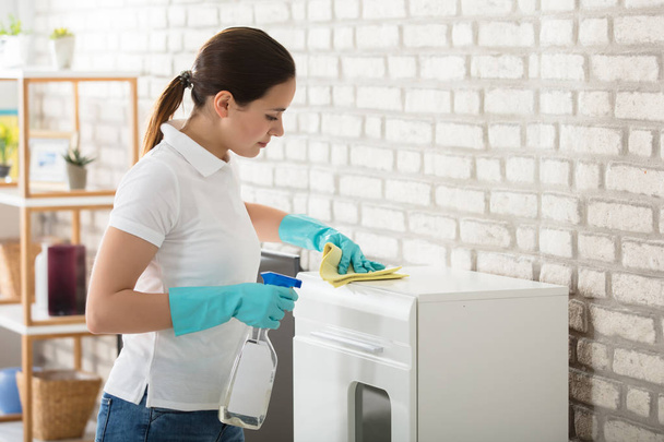 Young Woman Cleaning Cabinet - Φωτογραφία, εικόνα