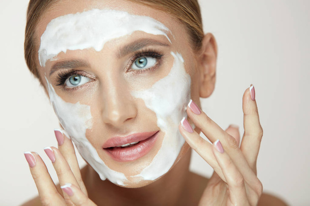 Face Washing. Female Applying Cosmetic Product On Beauty Face - Photo, Image