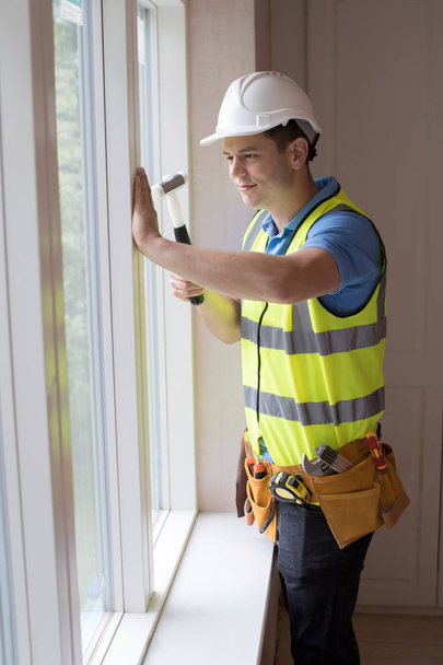 Construction Worker Installing New Windows In House - Valokuva, kuva