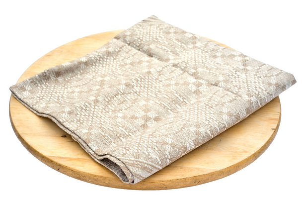 Beige linen sack burlap napkin on a round cutting board isolated on white background. - Photo, Image