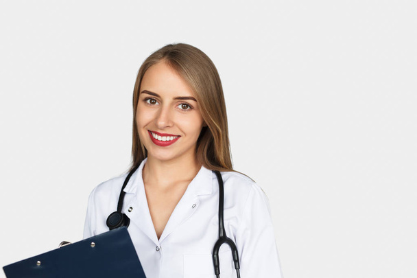 Young doctor holding sheet holder - Photo, Image