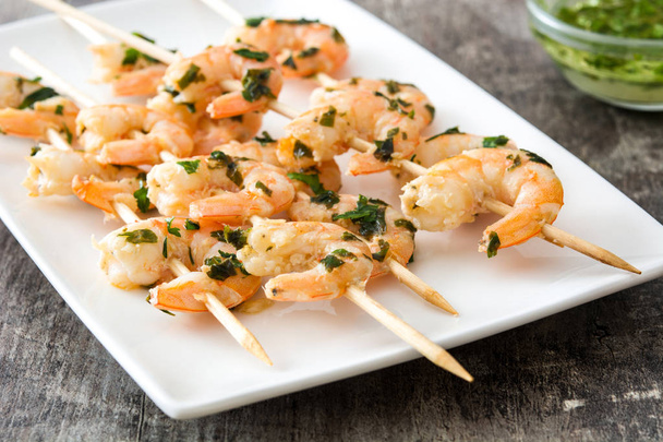 Shrimp skewers on wooden table - Photo, Image